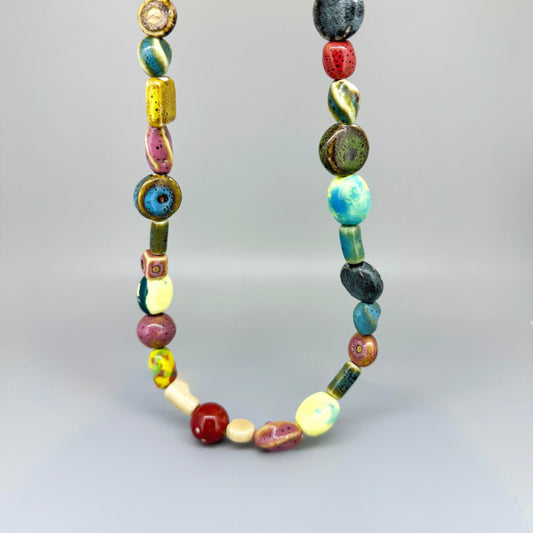 Multicolored ceramic beaded necklace, 50 cm / 19.7 in long, featuring handmade glazed beads in bright and earthy tones.
