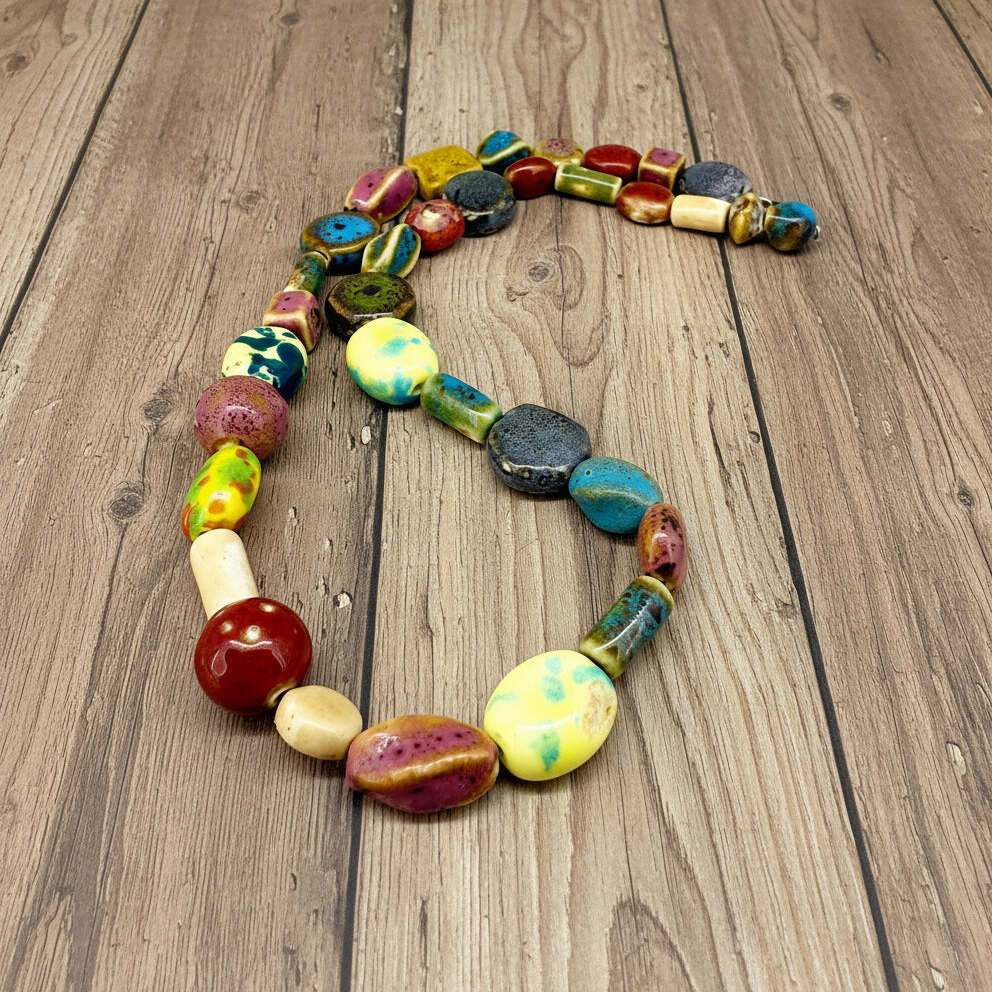 Multicolored ceramic beaded necklace, 50 cm / 19.7 in long, featuring handmade glazed beads in bright and earthy tones.