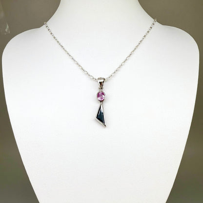 Handcrafted three-pendant gemstone necklace with sapphires, ruby, spinel, and tsavorite (5.81 ct total) on a black leather cord — modular design in white-gold-plated silver.