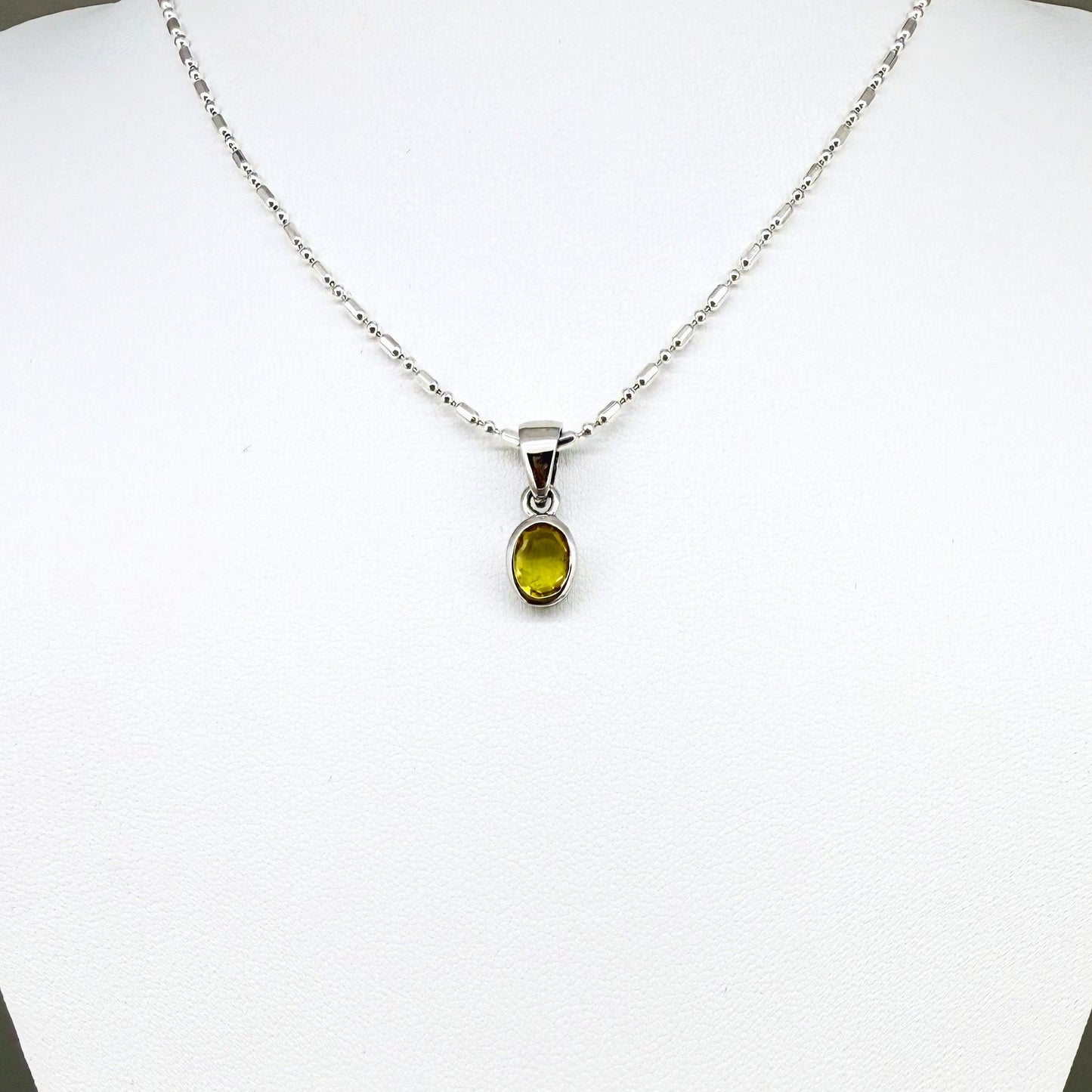 Handcrafted three-pendant gemstone necklace with sapphires, ruby, spinel, and tsavorite (5.81 ct total) on a black leather cord — modular design in white-gold-plated silver.