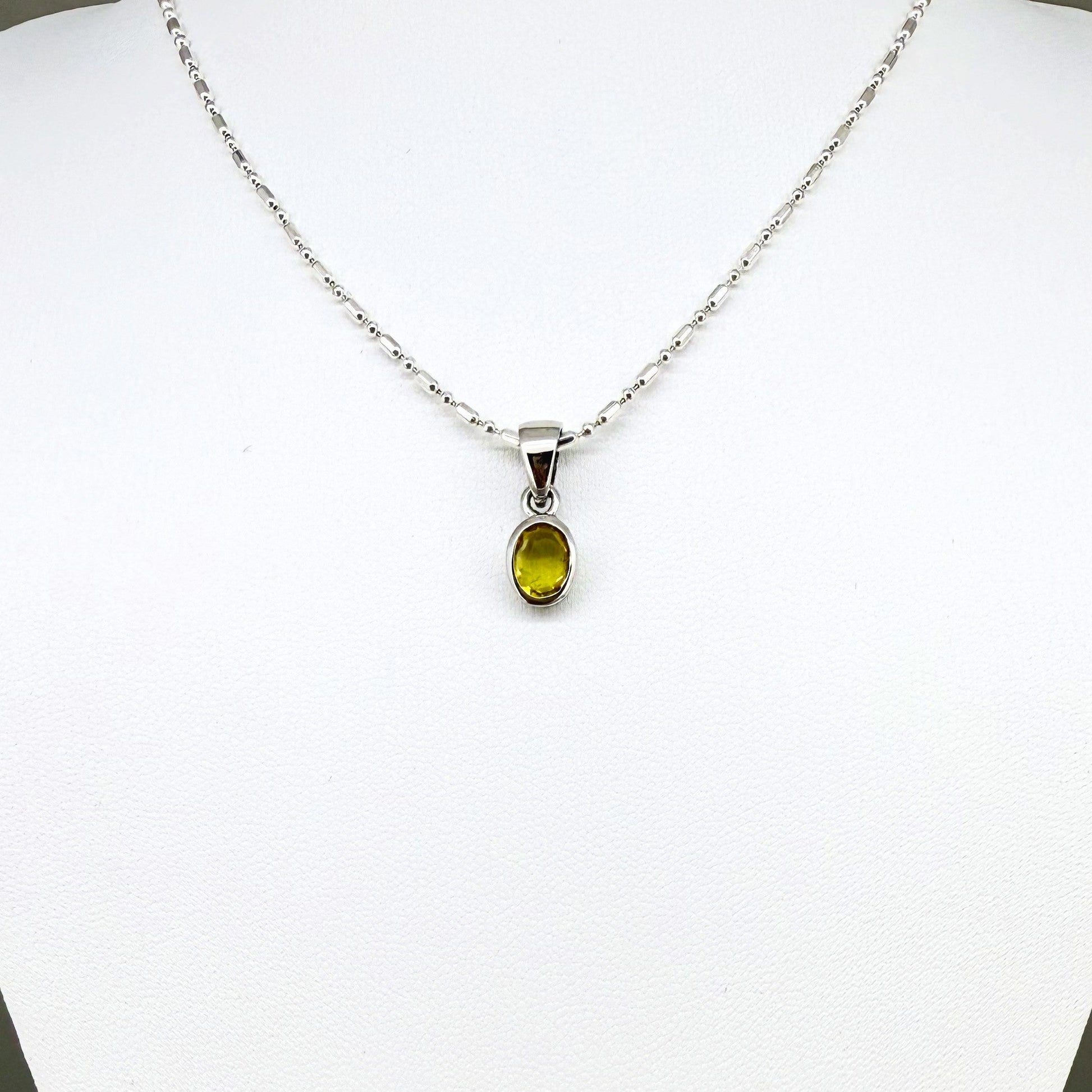 Handcrafted three-pendant gemstone necklace with sapphires, ruby, spinel, and tsavorite (5.81 ct total) on a black leather cord — modular design in white-gold-plated silver.