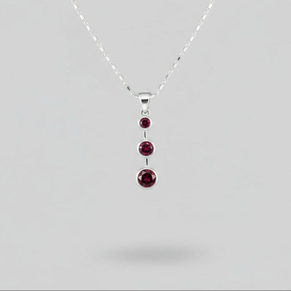 Handcrafted pendant with three natural rubies (2.92 ct total) set vertically in white-gold-plated sterling silver.