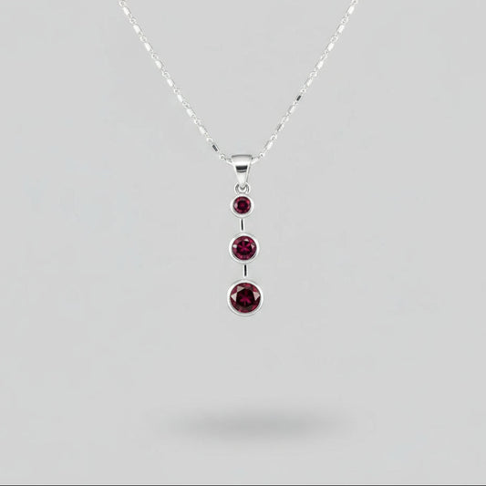 Handcrafted pendant with three natural rubies (2.92 ct total) set vertically in white-gold-plated sterling silver.