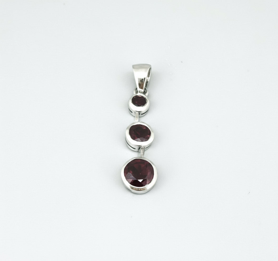 Handcrafted pendant with three natural rubies (2.92 ct total) set vertically in white-gold-plated sterling silver.