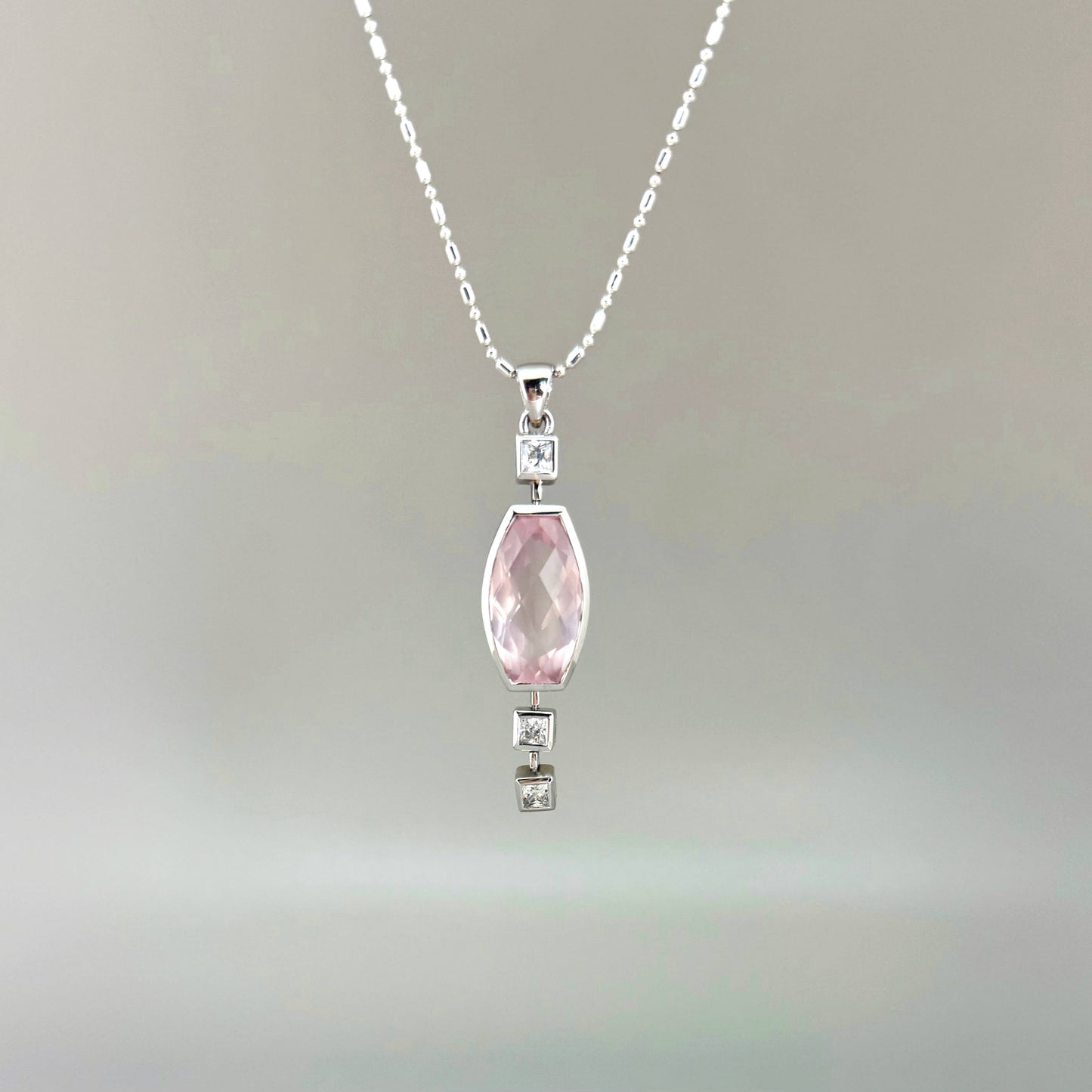 Handmade white gold plated silver pendant with 14.76 ct rose quartz and cubic zirconia accents, elegant and refined design.