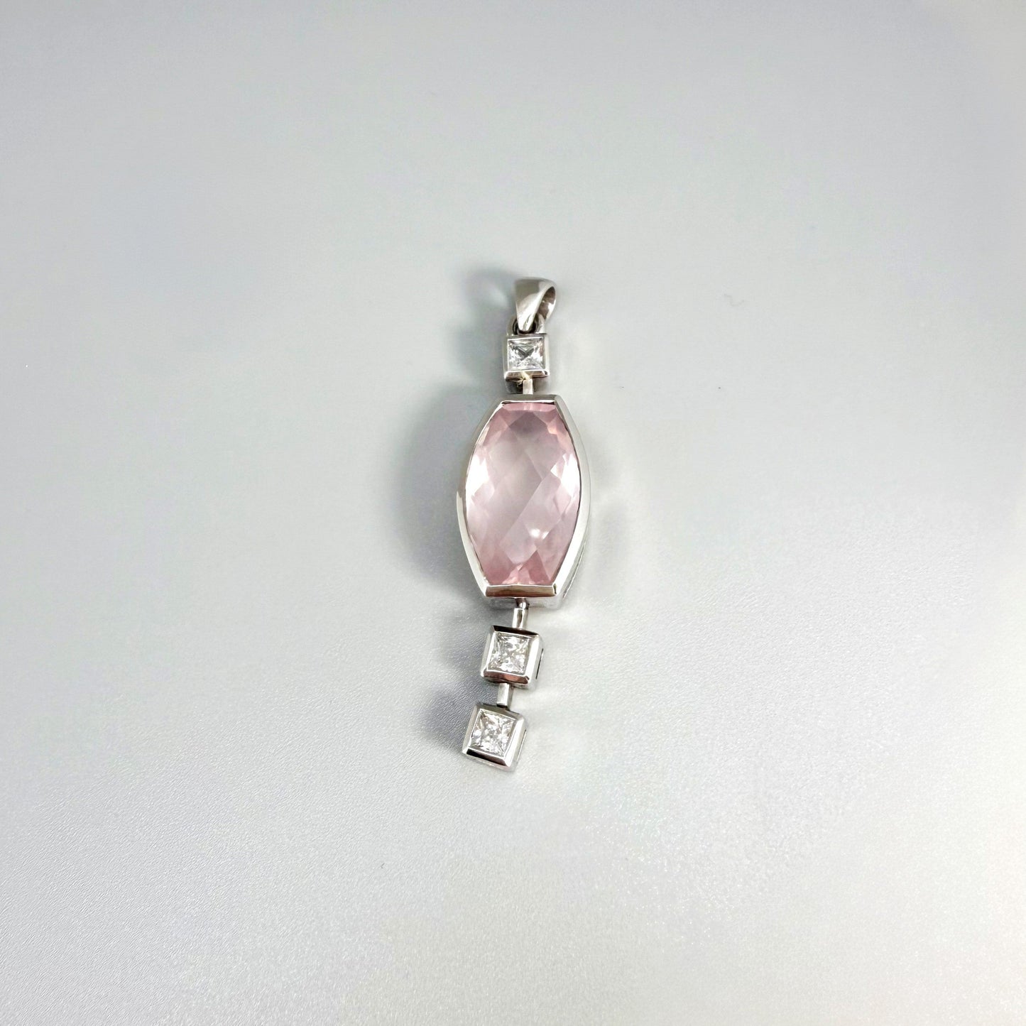 Handmade white gold plated silver pendant with 14.76 ct rose quartz and cubic zirconia accents, elegant and refined design.