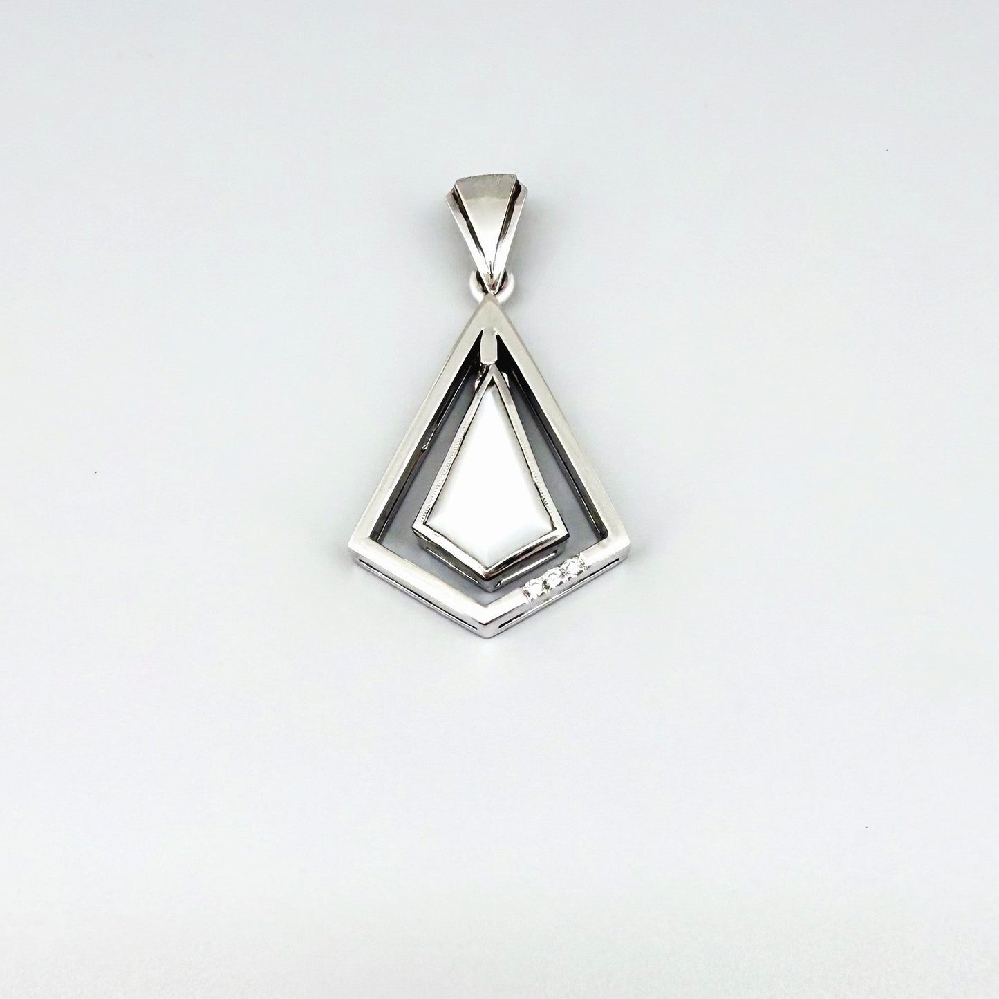 Handcrafted white gold-plated silver pendant with 4.04 ct moonstone and cubic zirconia accents in a geometric design.