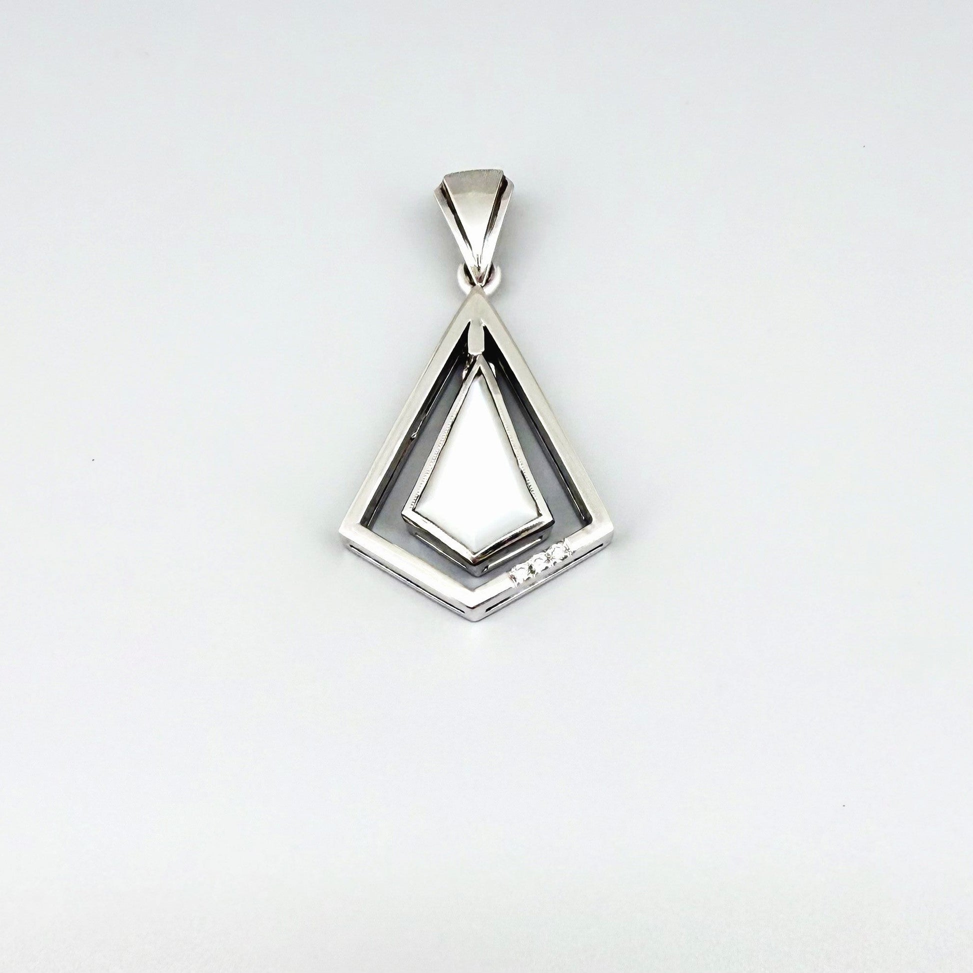 Handcrafted white gold-plated silver pendant with 4.04 ct moonstone and cubic zirconia accents in a geometric design.