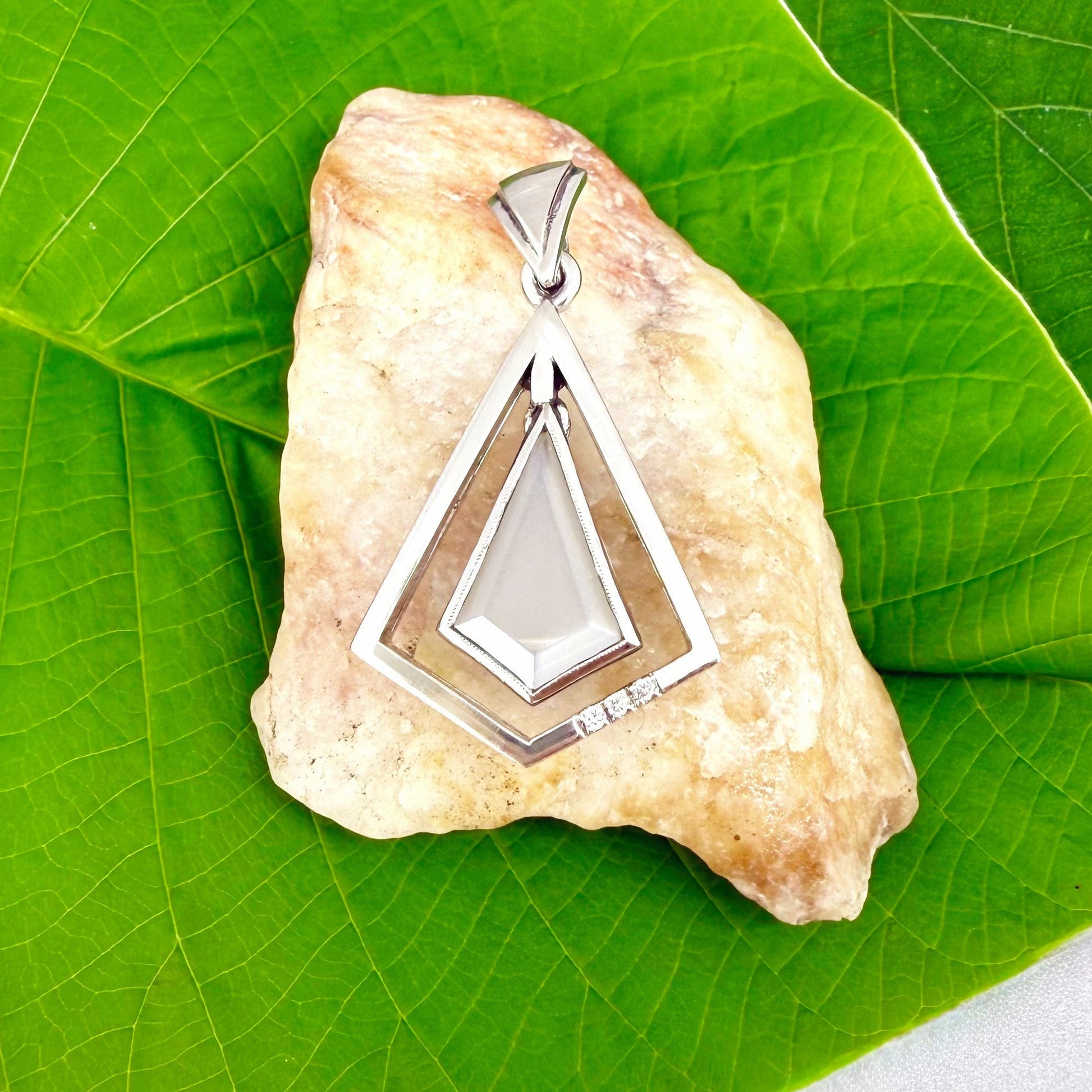 Handcrafted white gold-plated silver pendant with 4.04 ct moonstone and cubic zirconia accents in a geometric design.