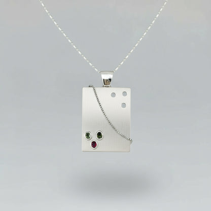 Handcrafted rectangular silver pendant with three natural tourmalines in green, pink, and yellow (2.16 ct total).