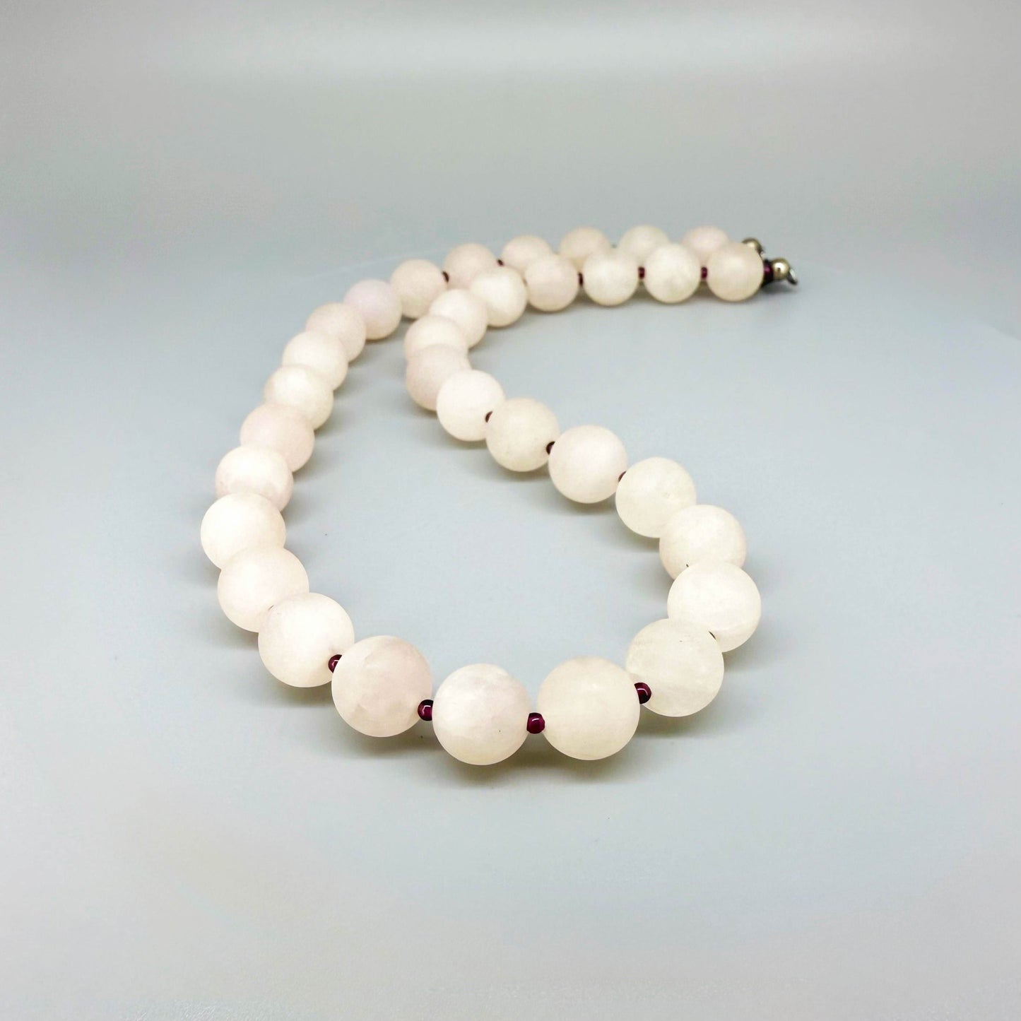 Matte rose quartz beaded necklace, 44 cm long, featuring softly polished natural rose quartz spheres in pale pink tones.