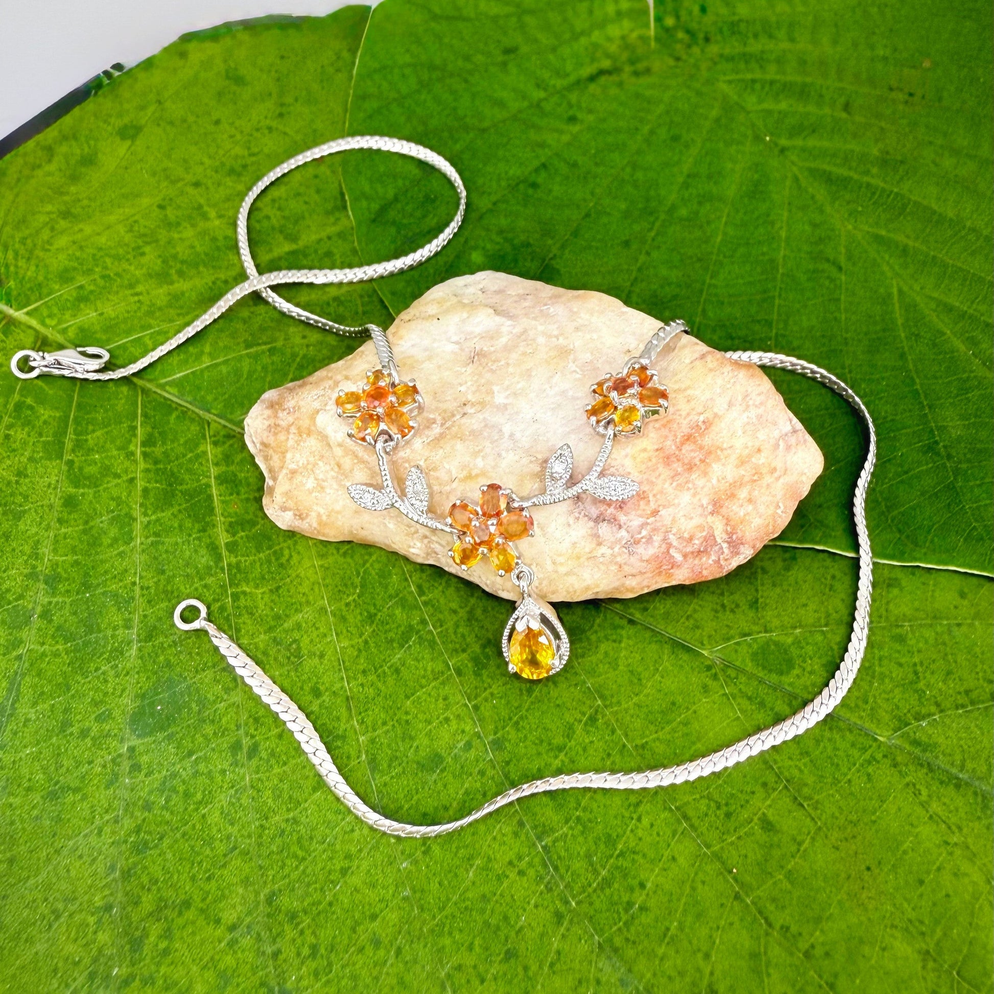 Handcrafted sterling silver necklace with natural orange sapphires in a floral design, 45 cm length.