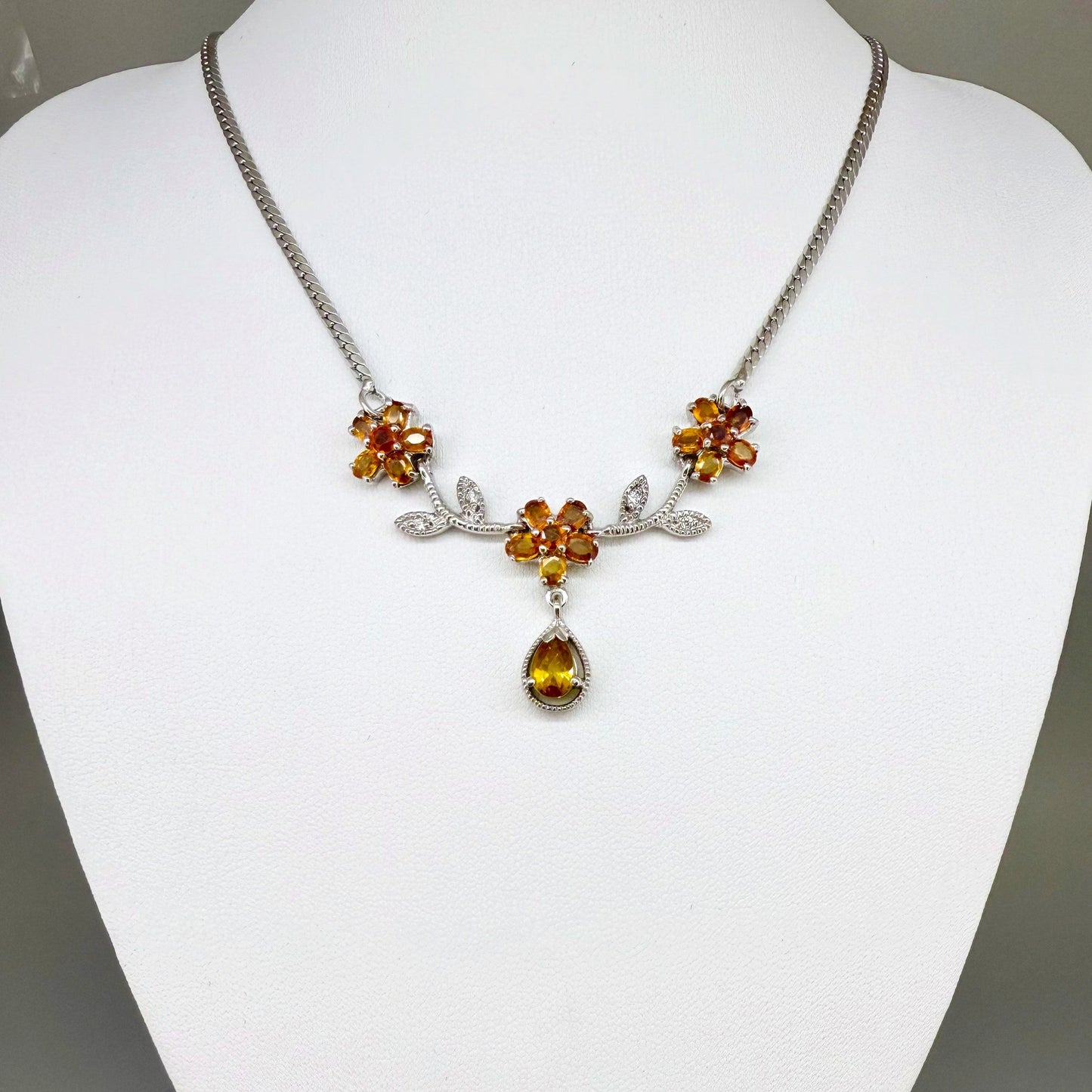 Handcrafted sterling silver necklace with natural orange sapphires in a floral design, 45 cm length.