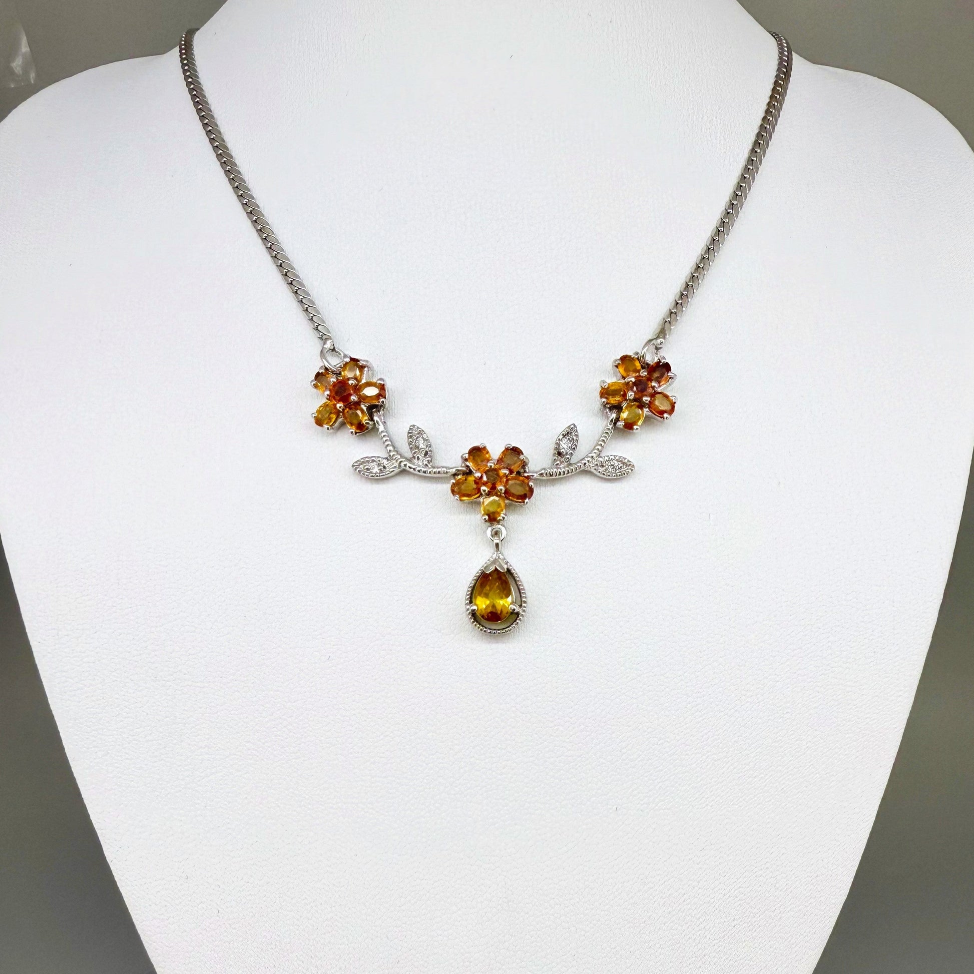 Handcrafted sterling silver necklace with natural orange sapphires in a floral design, 45 cm length.