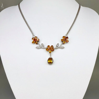 Handcrafted sterling silver necklace with natural orange sapphires in a floral design, 45 cm length.