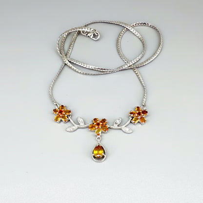 Handcrafted sterling silver necklace with natural orange sapphires in a floral design, 45 cm length.