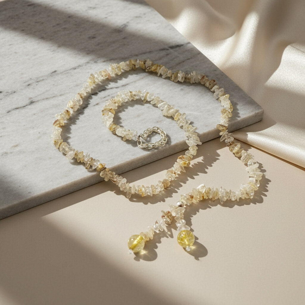 Golden rutilated quartz necklace with polished beads and a stainless-steel loop closure, styled as a drop-through design.