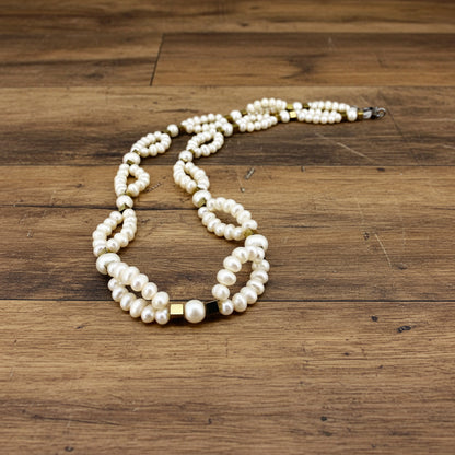 Pearl necklace on a wooden surface