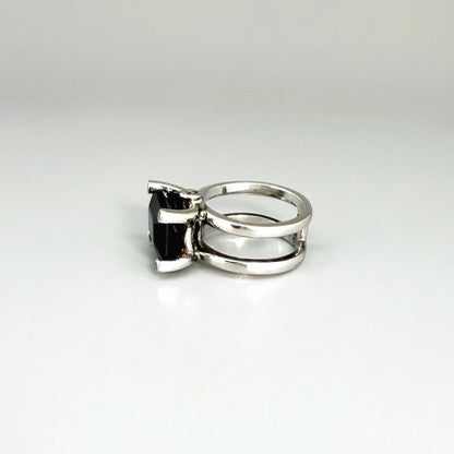 Emerald-cut sapphire ring in white gold plated sterling silver, featuring a natural deep blue gemstone in a bold and elegant solitaire design.