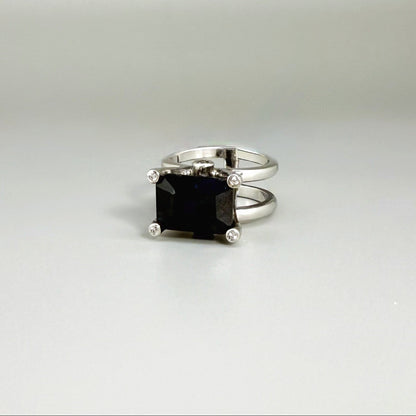 Emerald-cut sapphire ring in white gold plated sterling silver, featuring a natural deep blue gemstone in a bold and elegant solitaire design.