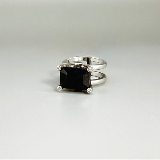 Emerald-cut sapphire ring in white gold plated sterling silver, featuring a natural deep blue gemstone in a bold and elegant solitaire design.