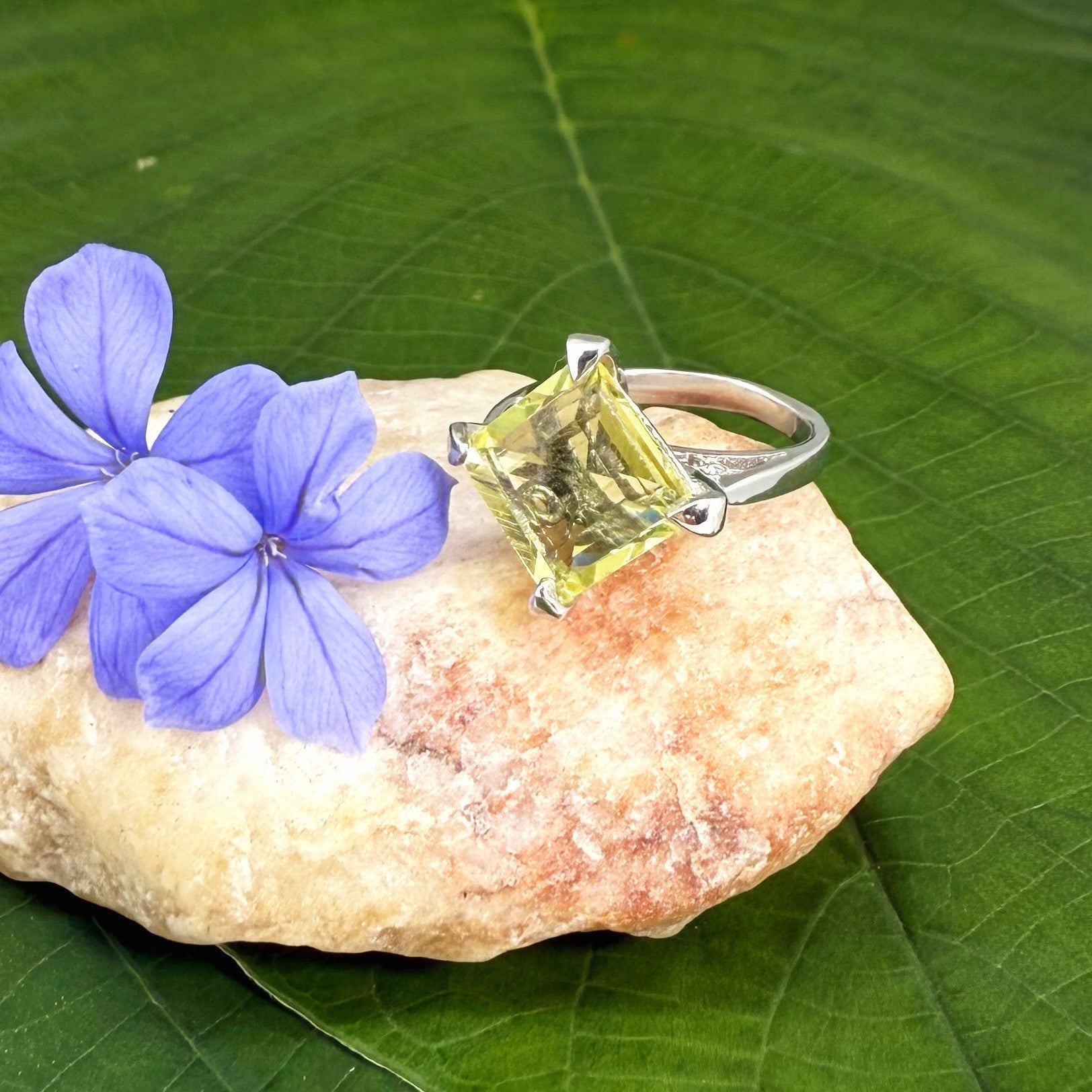 Lemon quartz solitaire ring in white gold plated sterling silver, featuring a rectangular faceted yellow gemstone, elegant and timeless design.