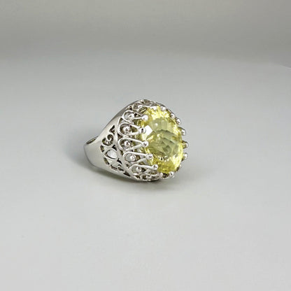 Statement ring with oval lemon quartz set in white gold plated sterling silver featuring intricate silver details and radiant yellow tones.