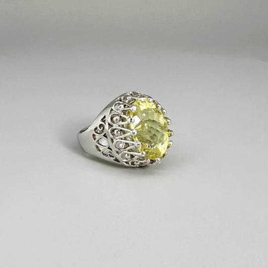 Statement ring with oval lemon quartz set in white gold plated sterling silver featuring intricate silver details and radiant yellow tones.