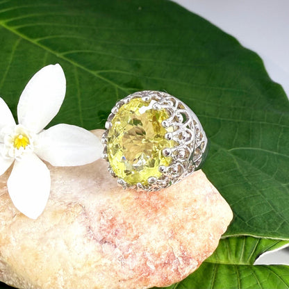 Statement ring with oval lemon quartz set in white gold plated sterling silver featuring intricate silver details and radiant yellow tones.