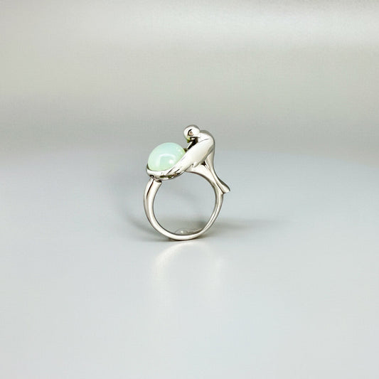 Handcrafted sterling silver ring with bird motif, featuring a 4.76 ct chalcedony cabochon resembling water in a fountain.