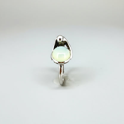 Handcrafted sterling silver ring with bird motif, featuring a 4.76 ct chalcedony cabochon resembling water in a fountain.
