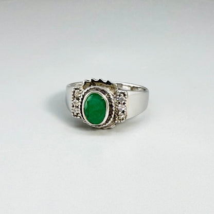 Green quartz cabochon ring in white gold plated sterling silver, featuring an oval vivid green gemstone with soft translucent glow and refined silver design.