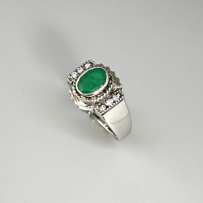 Green quartz cabochon ring in white gold plated sterling silver, featuring an oval vivid green gemstone with soft translucent glow and refined silver design.