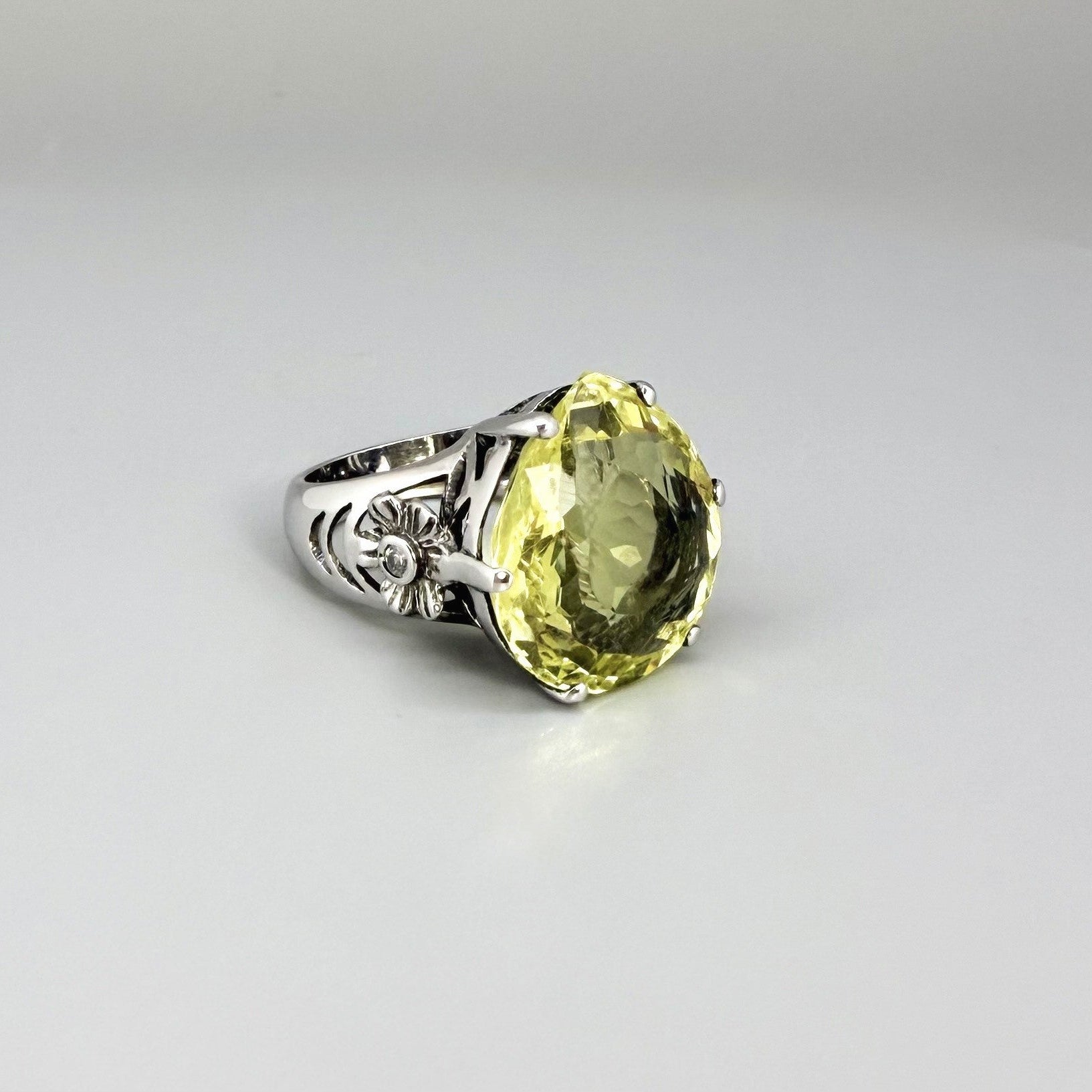 White gold plated sterling silver ring featuring an oval lemon quartz gemstone, bright yellow tones and elegant handcrafted design.