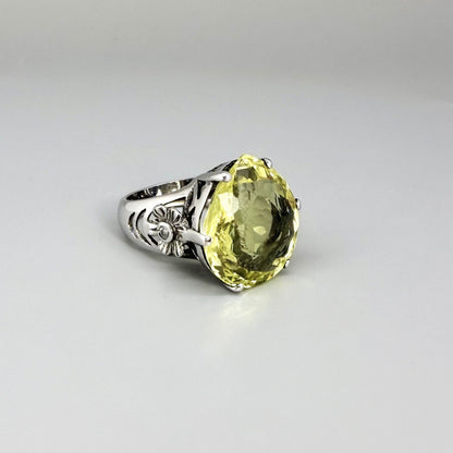 White gold plated sterling silver ring featuring an oval lemon quartz gemstone, bright yellow tones and elegant handcrafted design.