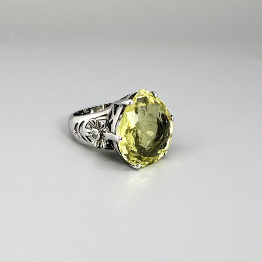 White gold plated sterling silver ring featuring an oval lemon quartz gemstone, bright yellow tones and elegant handcrafted design.
