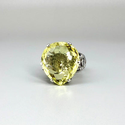 White gold plated sterling silver ring featuring an oval lemon quartz gemstone, bright yellow tones and elegant handcrafted design.