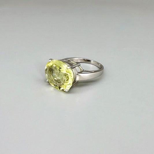 Lemon quartz solitaire ring in white gold plated sterling silver, featuring a large faceted yellow-green gemstone, bold and elegant design.