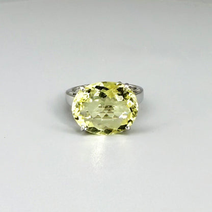 Lemon quartz solitaire ring in white gold plated sterling silver, featuring a large faceted yellow-green gemstone, bold and elegant design.