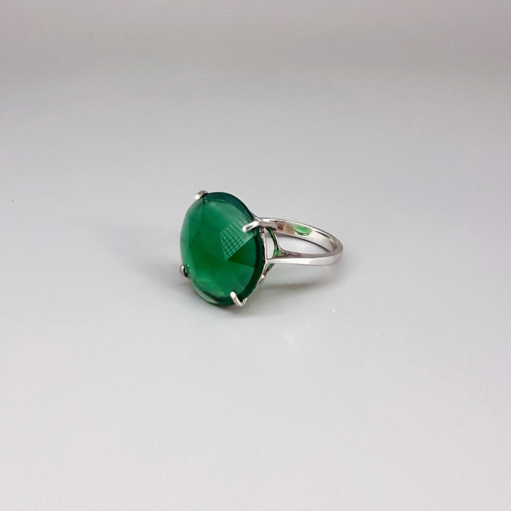 White gold plated sterling silver ring with large faceted green chalcedony gemstone, elegant solitaire design with rich natural color.