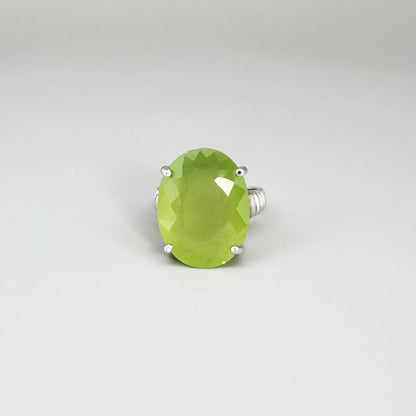 White gold plated sterling silver ring featuring an oval green quartz gemstone, elegant solitaire design with soft natural color.