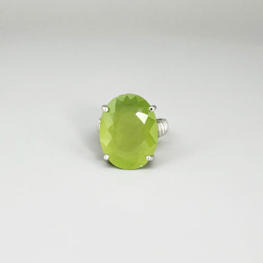 White gold plated sterling silver ring featuring an oval green quartz gemstone, elegant solitaire design with soft natural color.