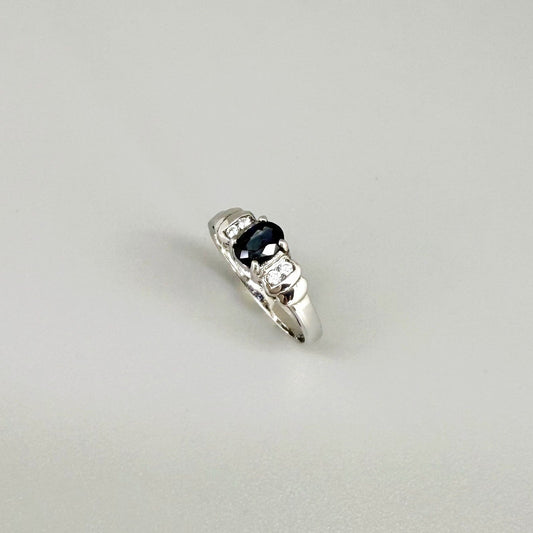 Sapphire and CZ ring in white gold plated sterling silver on neutral background