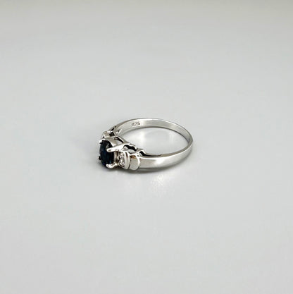Sapphire and CZ ring in white gold plated sterling silver on neutral background