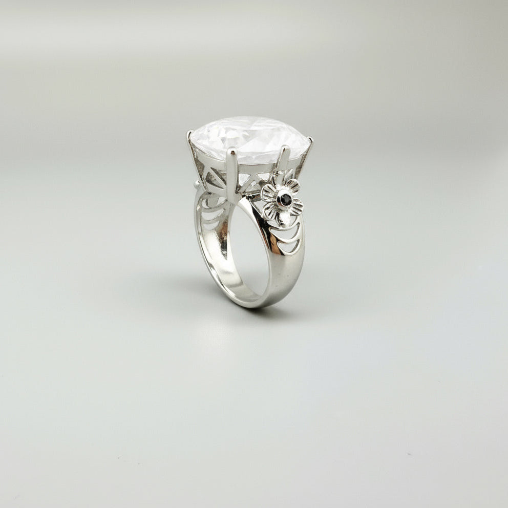 Handcrafted white gold-plated silver ring featuring a large 26.47 ct faceted white quartz gemstone.