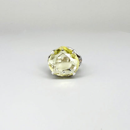 White gold plated sterling silver ring featuring a lemon quartz gemstone surrounded by orange sapphires in a halo design.