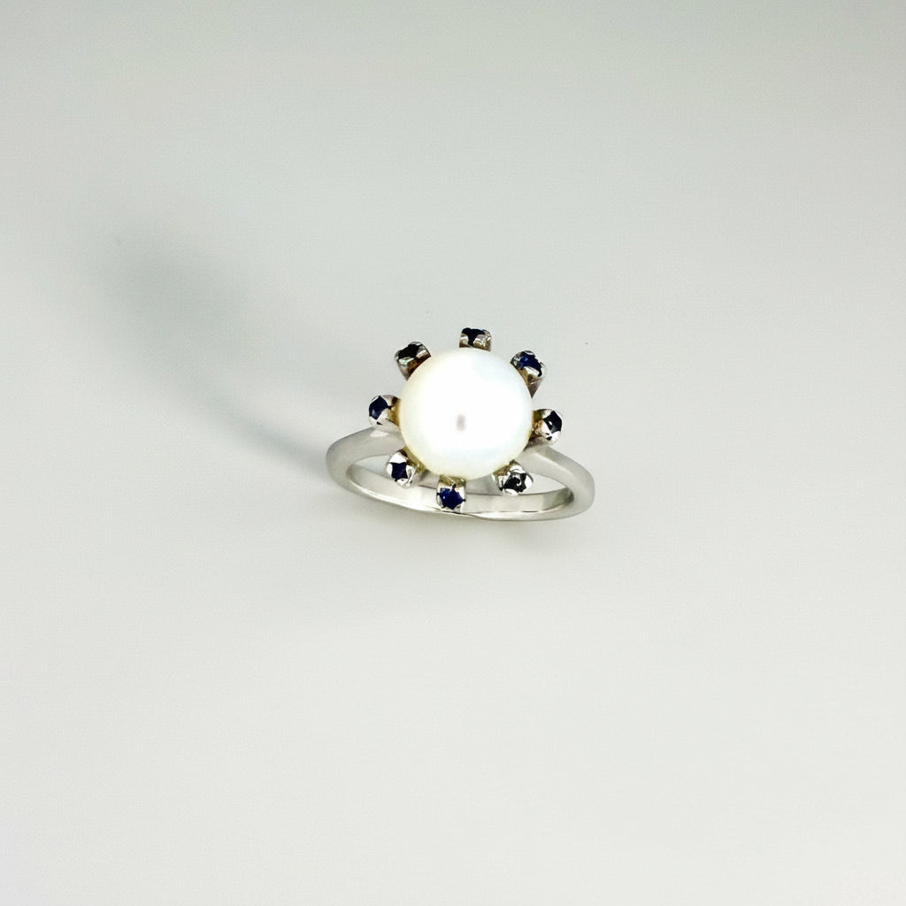 Handmade ring with 3.75 ct natural moonstone and 0.35 ct blue sapphires, set in white-gold-plated sterling silver.