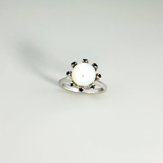 Handmade ring with 3.75 ct natural moonstone and 0.35 ct blue sapphires, set in white-gold-plated sterling silver.