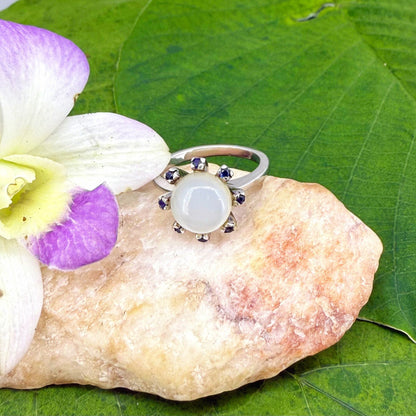 Handmade ring with 3.75 ct natural moonstone and 0.35 ct blue sapphires, set in white-gold-plated sterling silver.