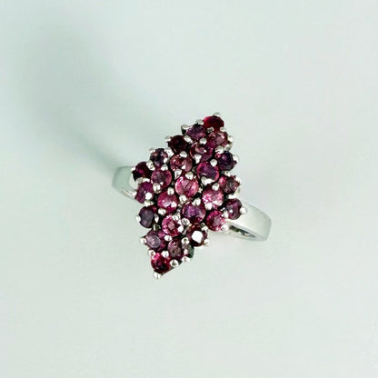 Ruby cluster ring in white gold plated sterling silver, featuring multiple faceted natural rubies in geometric design, elegant and radiant look.
